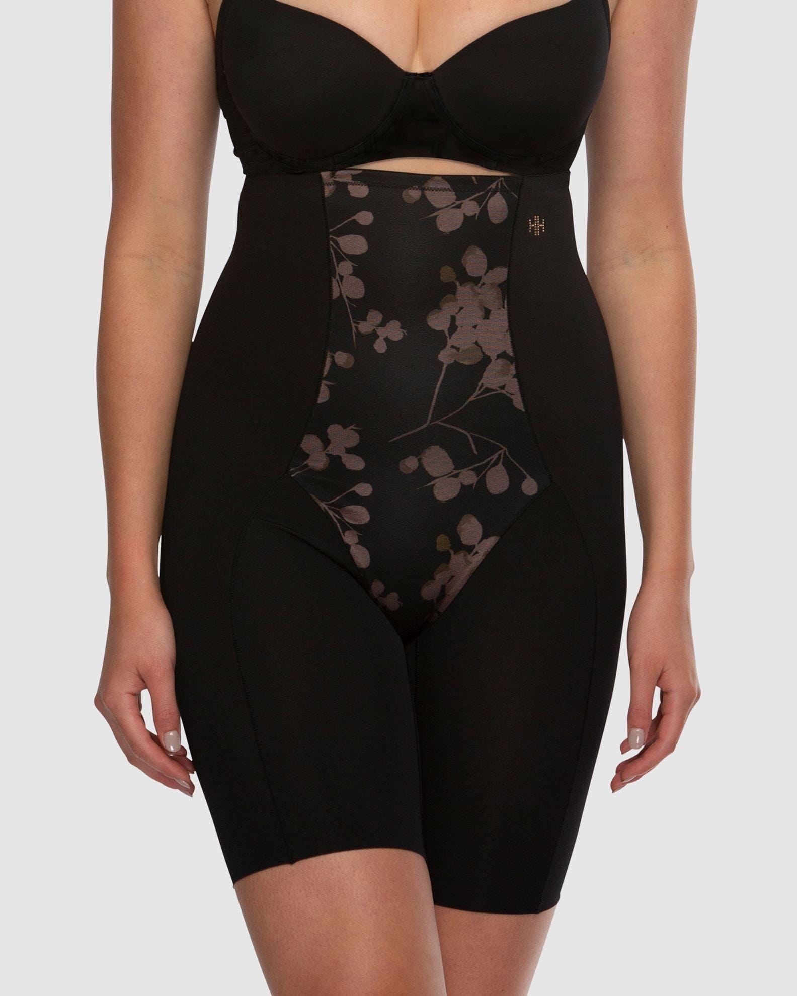 Black shapewear with floral pattern on a white background