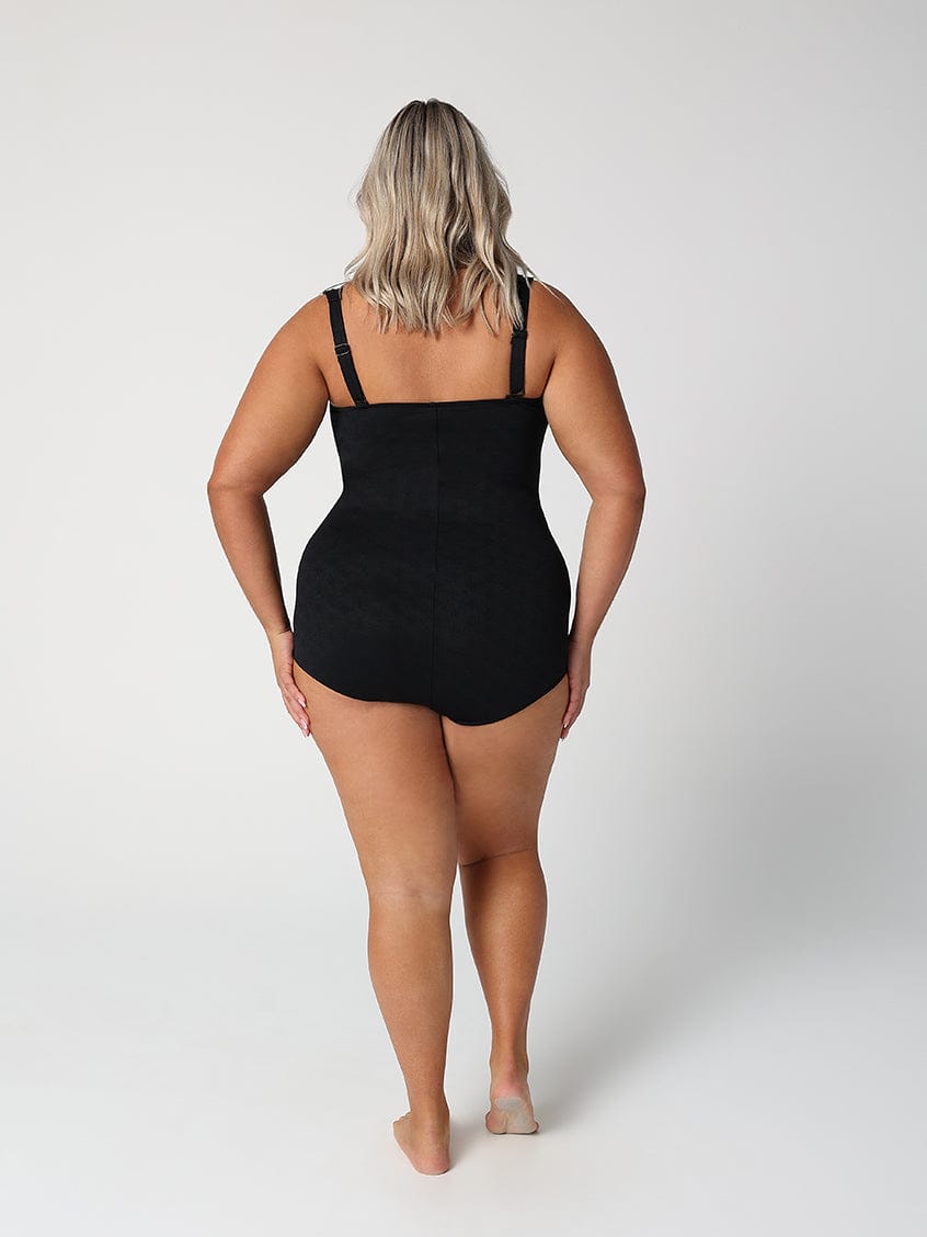 Person wearing a black swimsuit on a white background