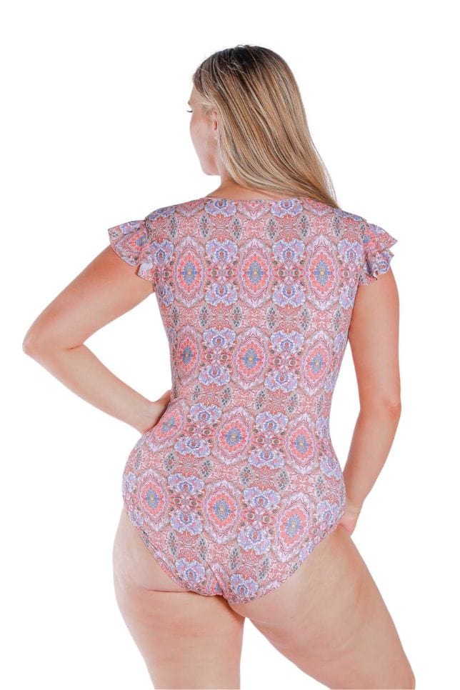 Back Shot of model wearing pink and red toned frilled sleeve one piece with zip front