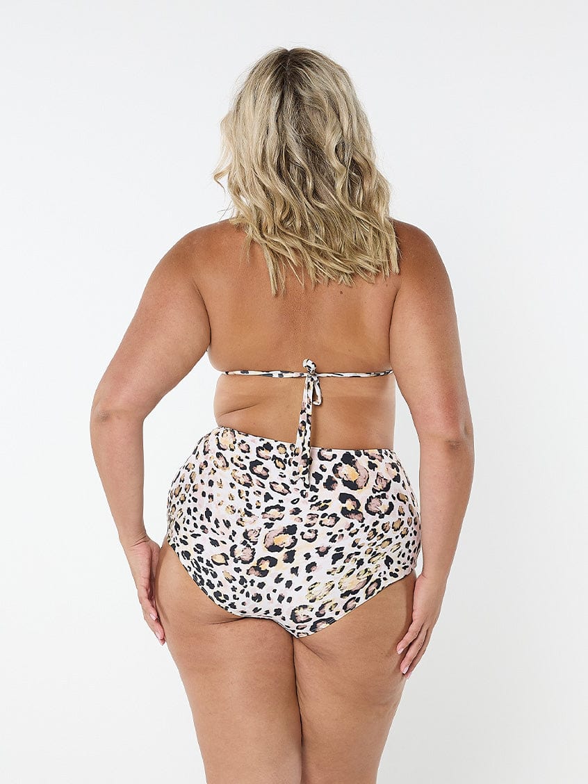 Side profile of blonde model wearing plus size bikini top in animal print