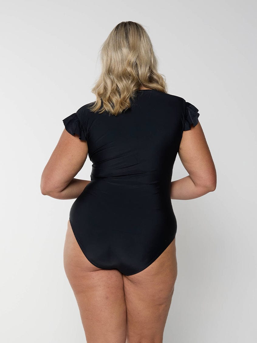 Model showing back of black frill sleeve swimsuit for plus size