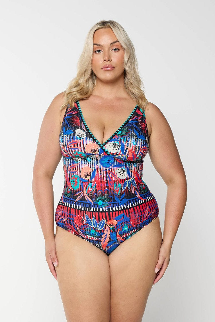 Front of model in studio wearing v neck one piece with embroidered neckline in multi coloured print