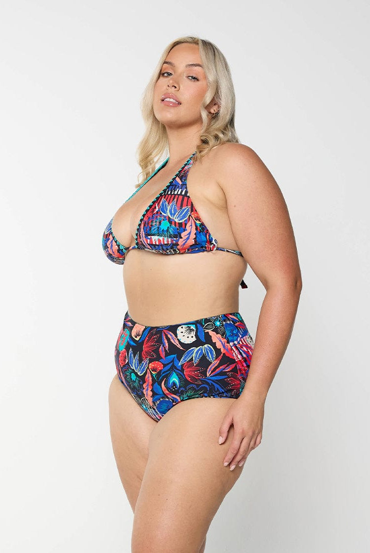Blonde model in studio wearing high waisted swim pant for plus size women