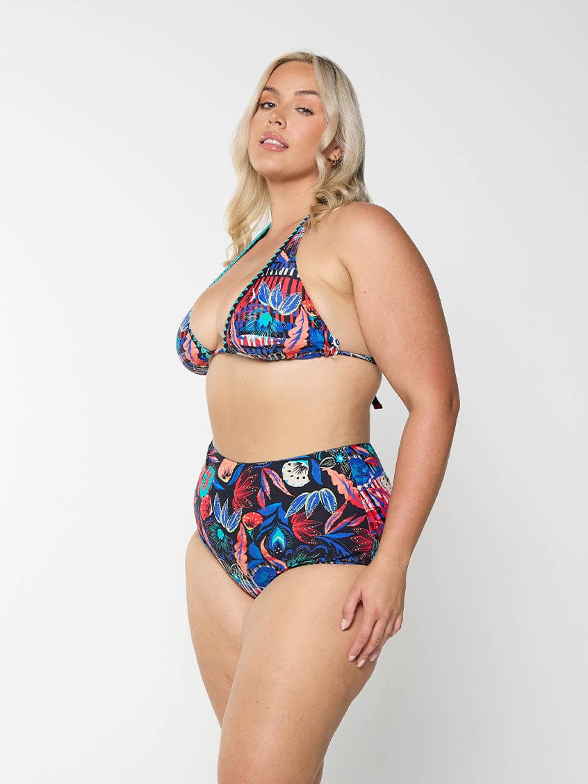 Blonde model in studio wearing high waisted swim pant for plus size women