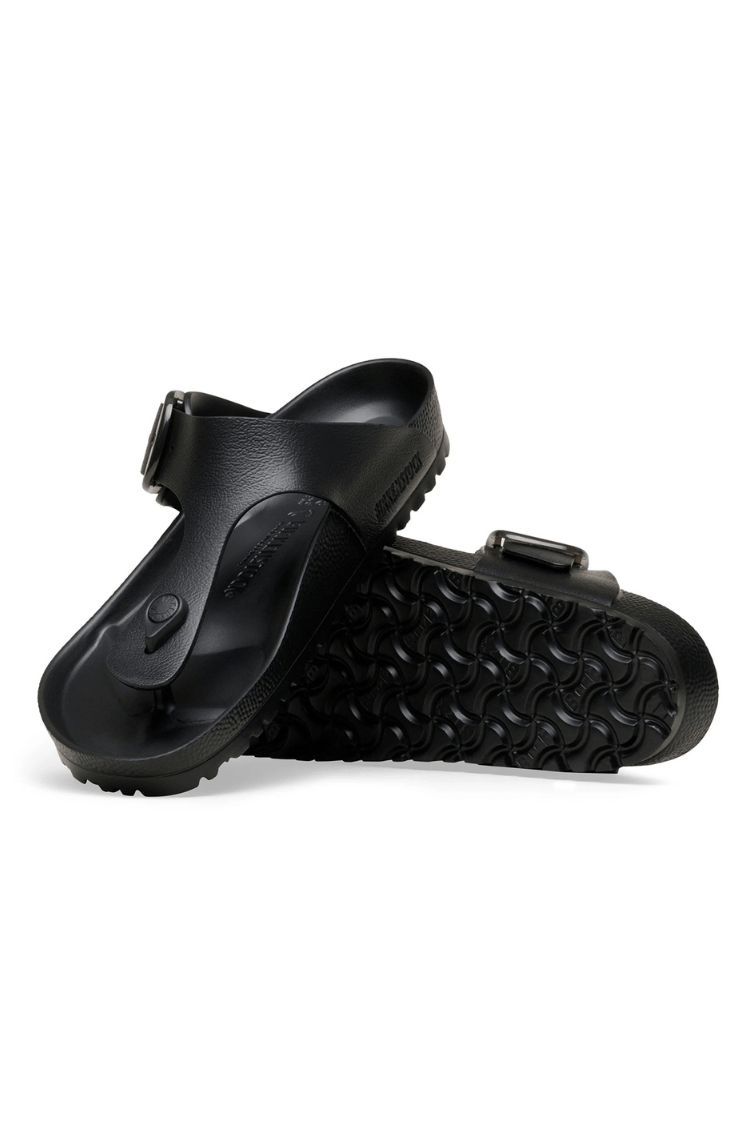 A pair of black slide sandals with adjustable straps and textured soles, shown from a side angle on a white background.