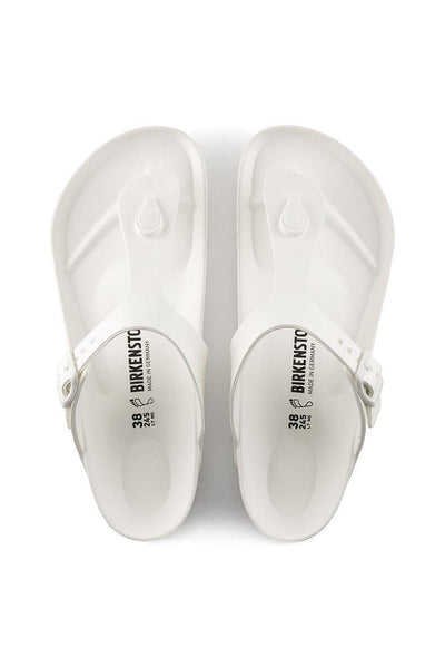 overview photo of the white T style flat rubber sandal