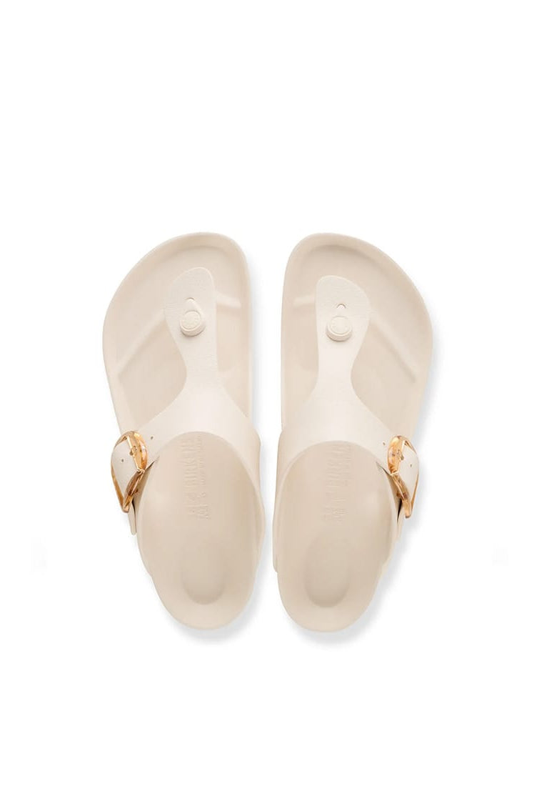 A pair of Birkenstock Florida slide sandals in a light cream color with gold-tone buckle straps, shown from a top-down view on a white background.