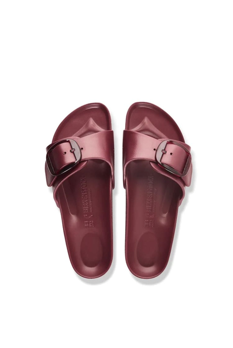 A pair of metallic burgundy slide sandals with double straps and silver-tone buckle details, shown from a top-down view on a white background.