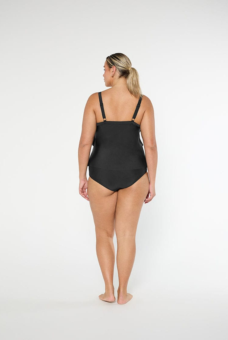 Woman wearing a black swimsuit on a white background