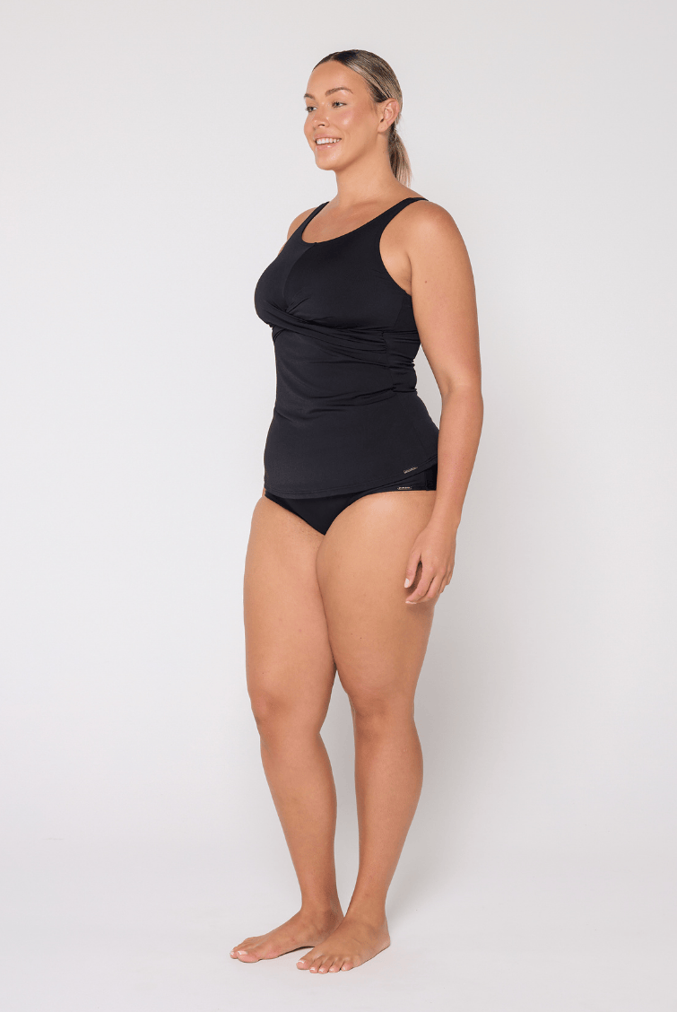Side profile of woman in studio wearing a high neck tankini top