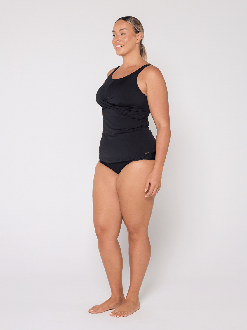 Side profile of woman in studio wearing a high neck tankini top