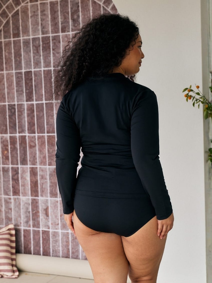 Back of model wearing a long sleeve chlorine resistant rashie in black