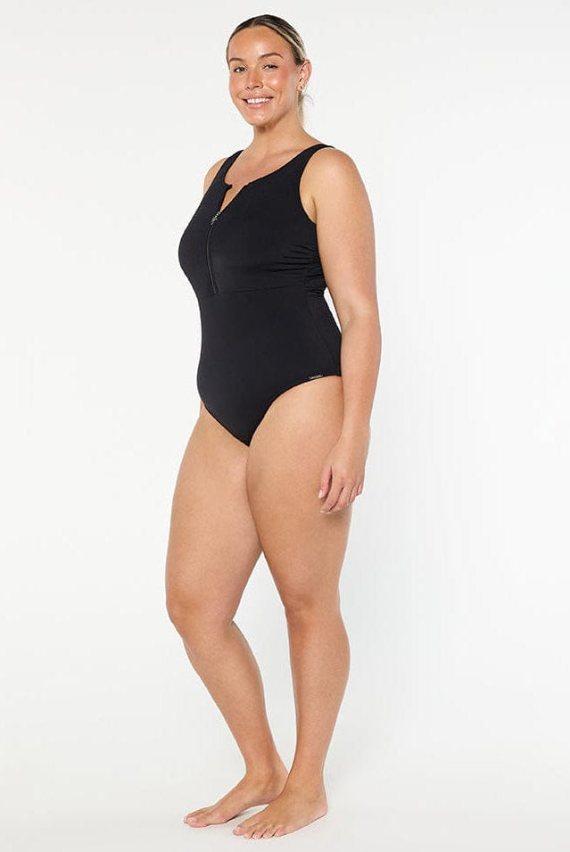 Woman wearing a black swimsuit on a white background