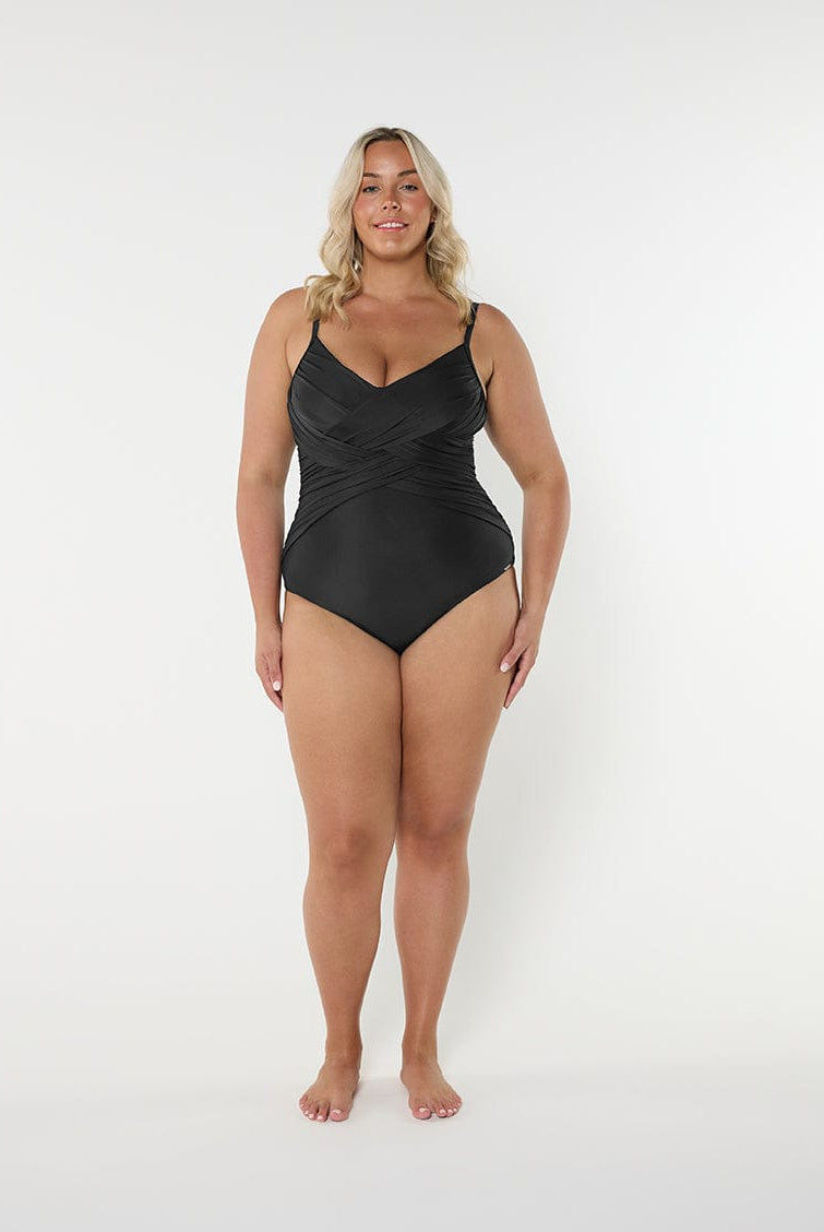 Woman wearing a black swimsuit on a white background