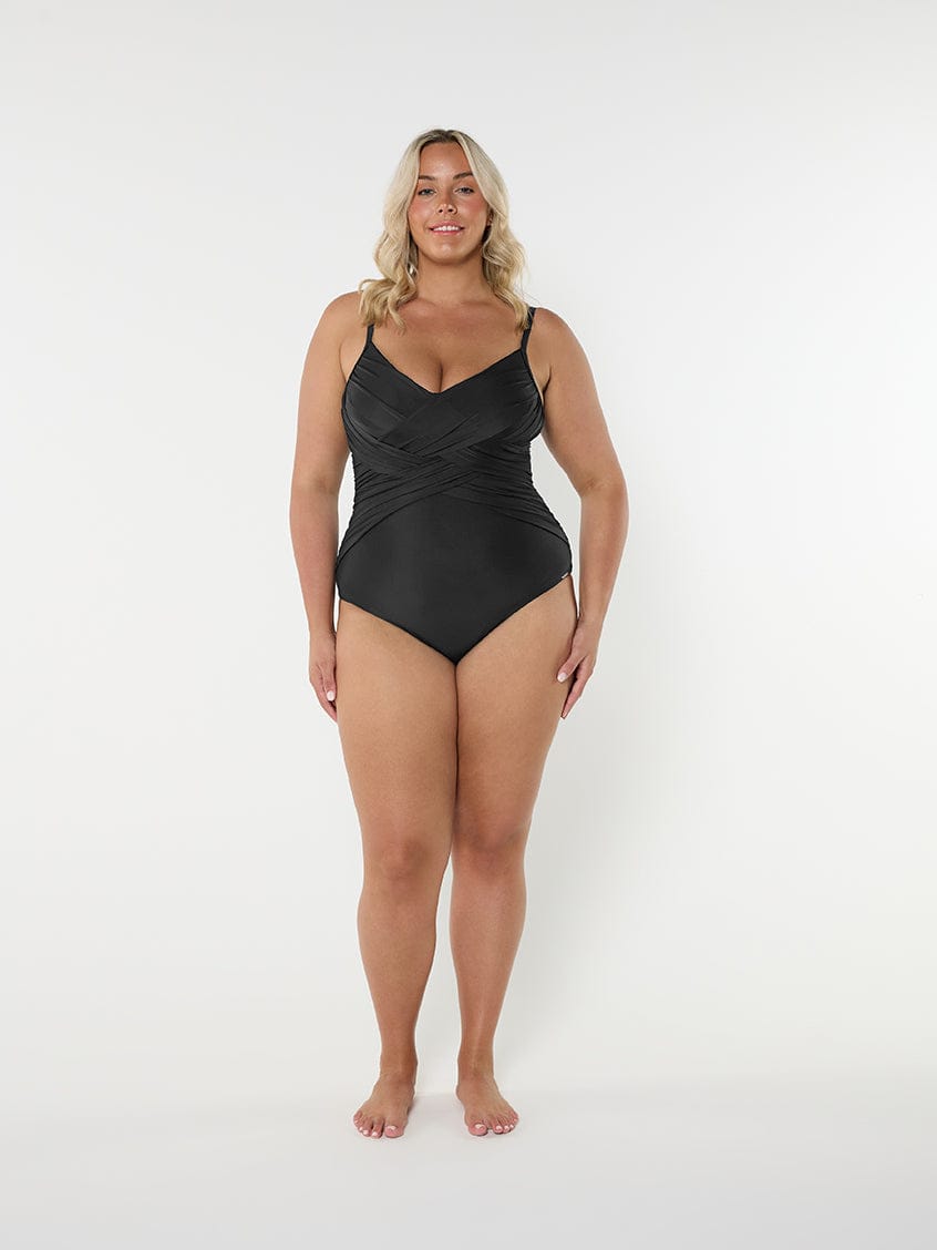 Woman wearing a black swimsuit on a white background