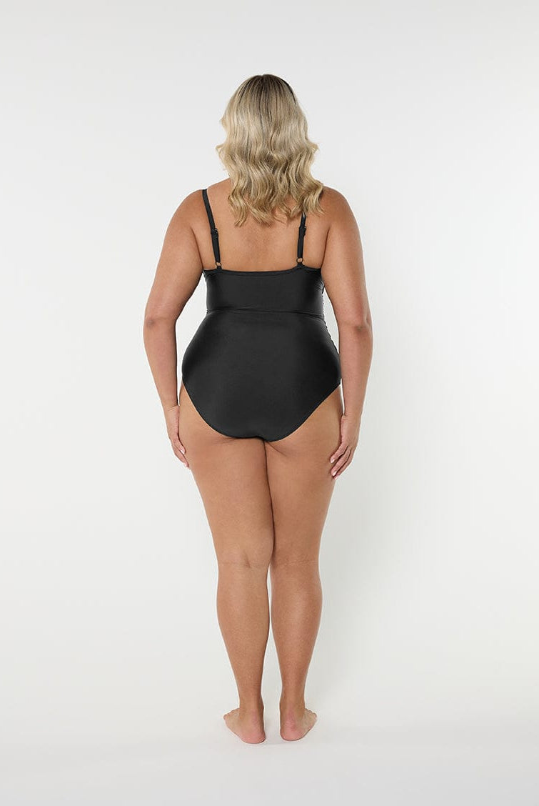 Person wearing a black swimsuit on a white background