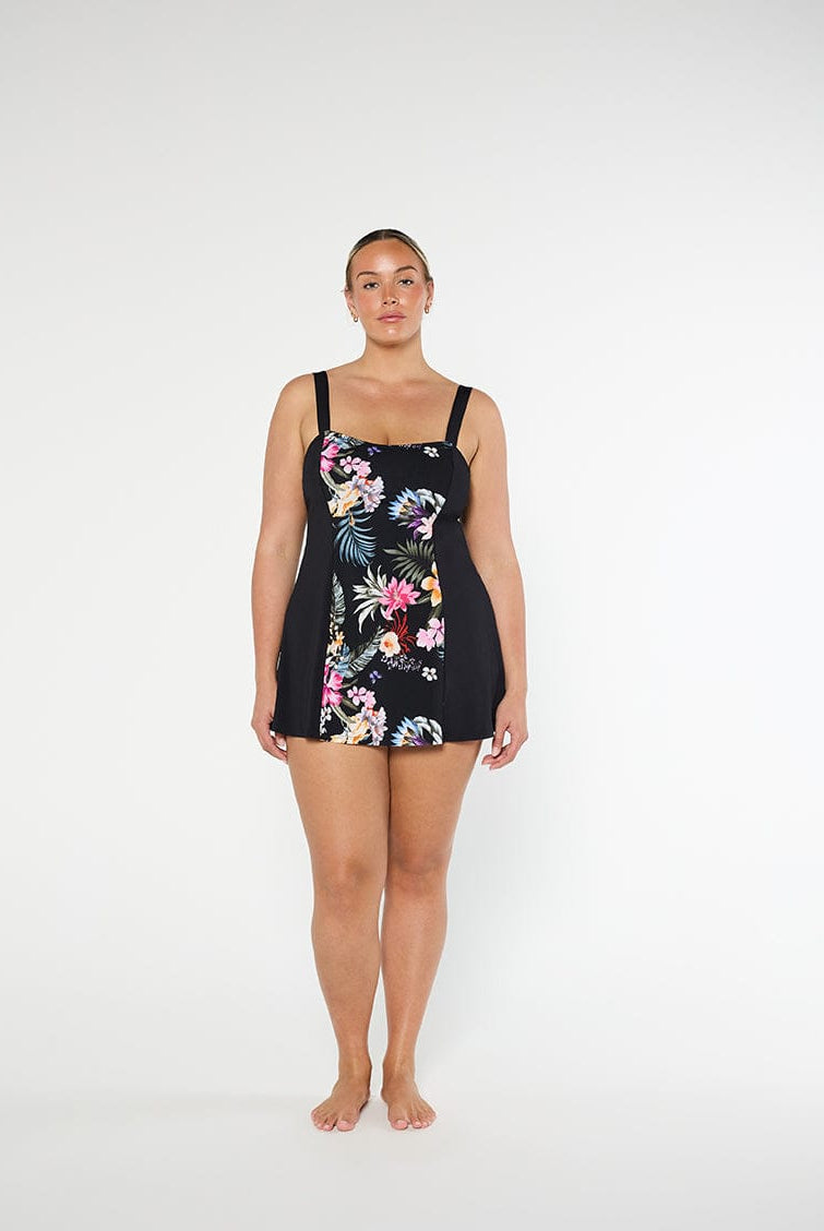 Woman wearing a black floral swimsuit on a white background