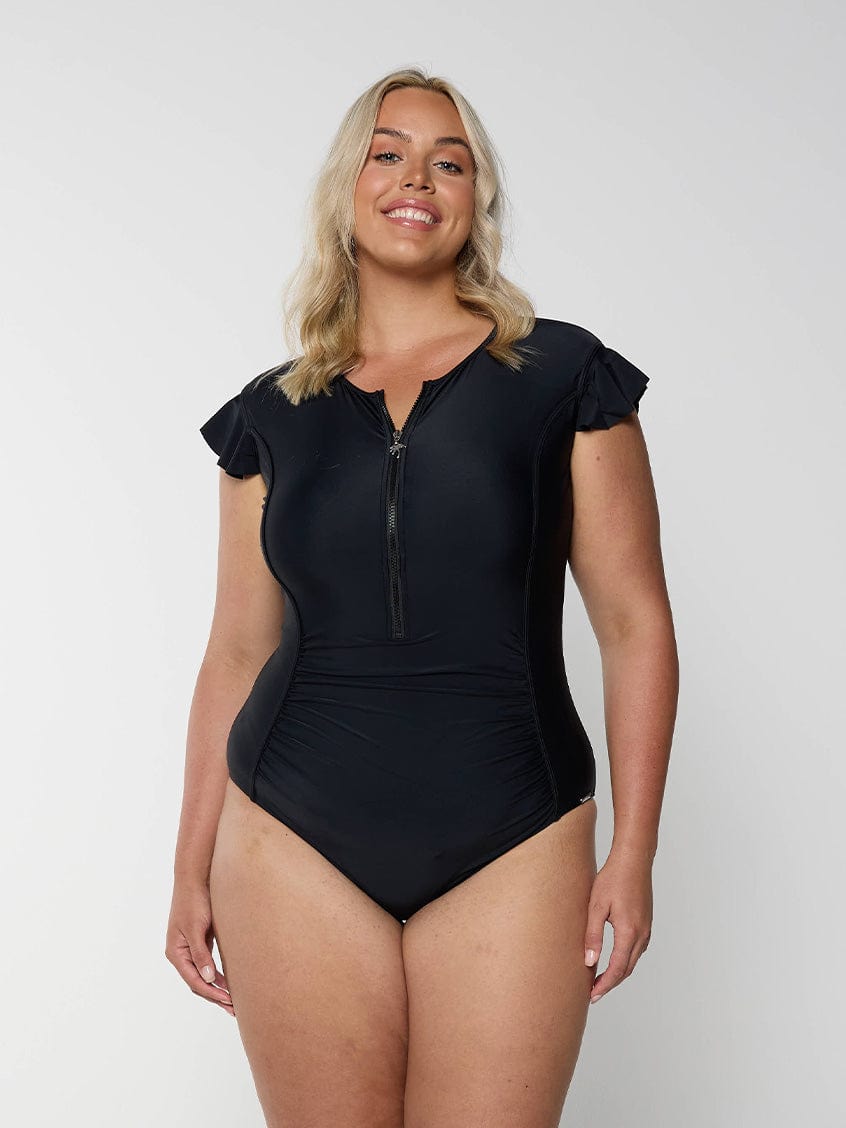 Blonde model wearing plain black frill sleeve swimsuit