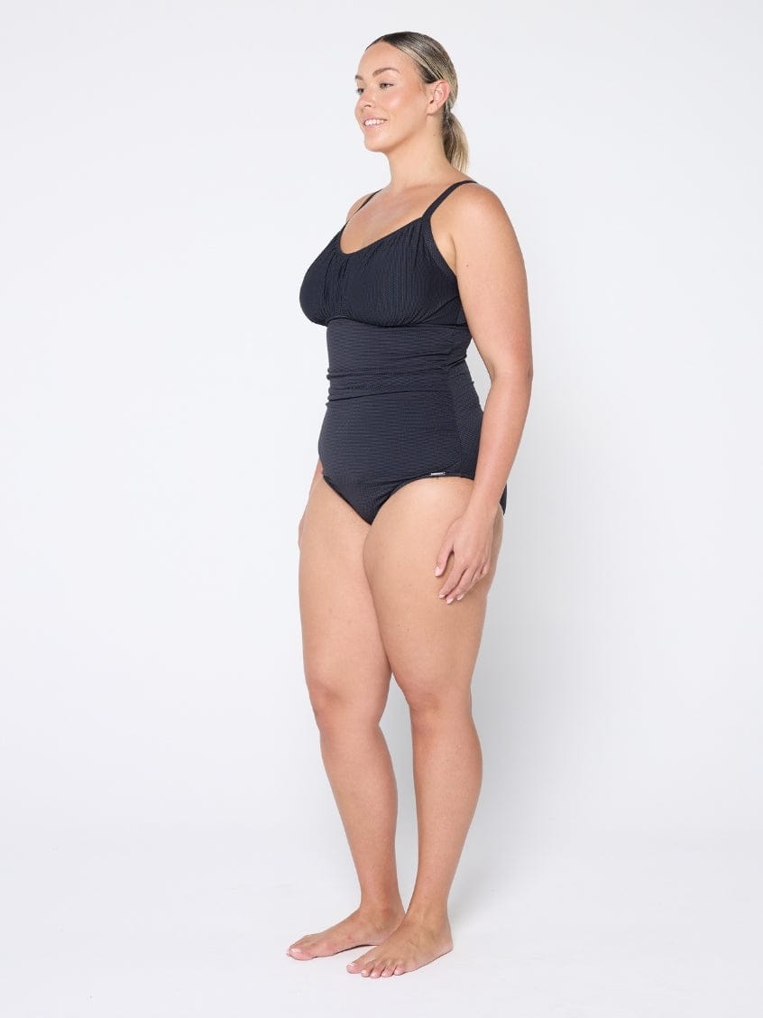 Woman wearing a black swimsuit on a white background