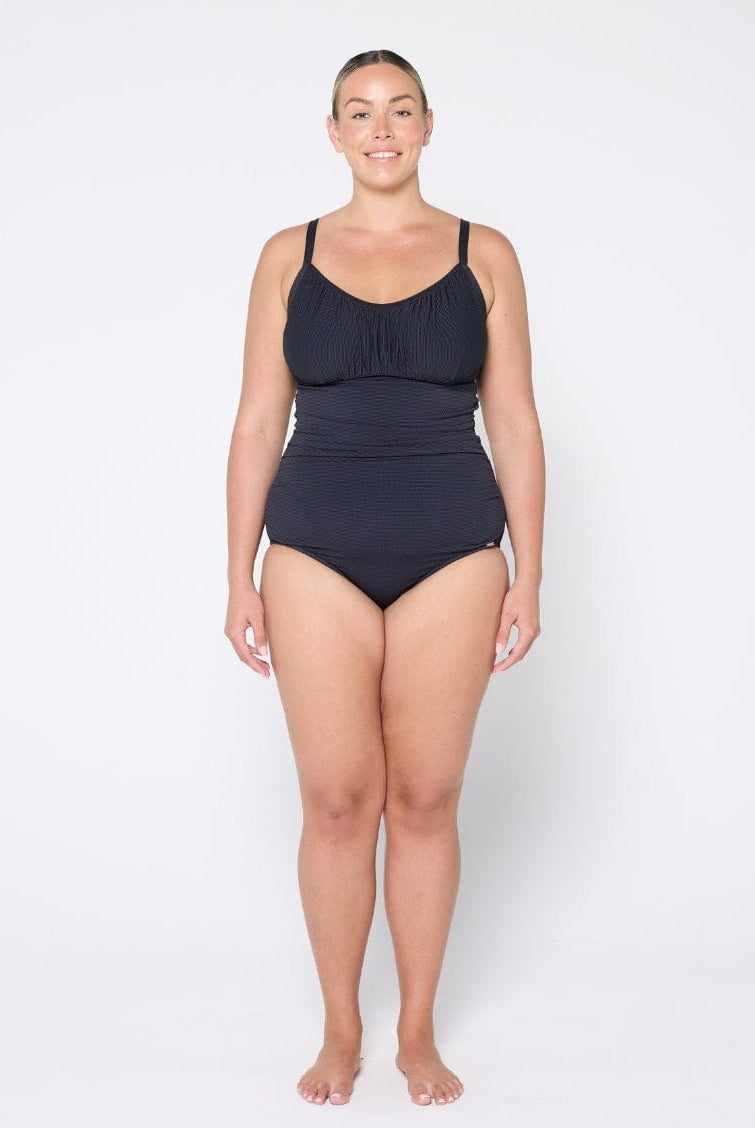 Woman wearing a black swimsuit on a white background
