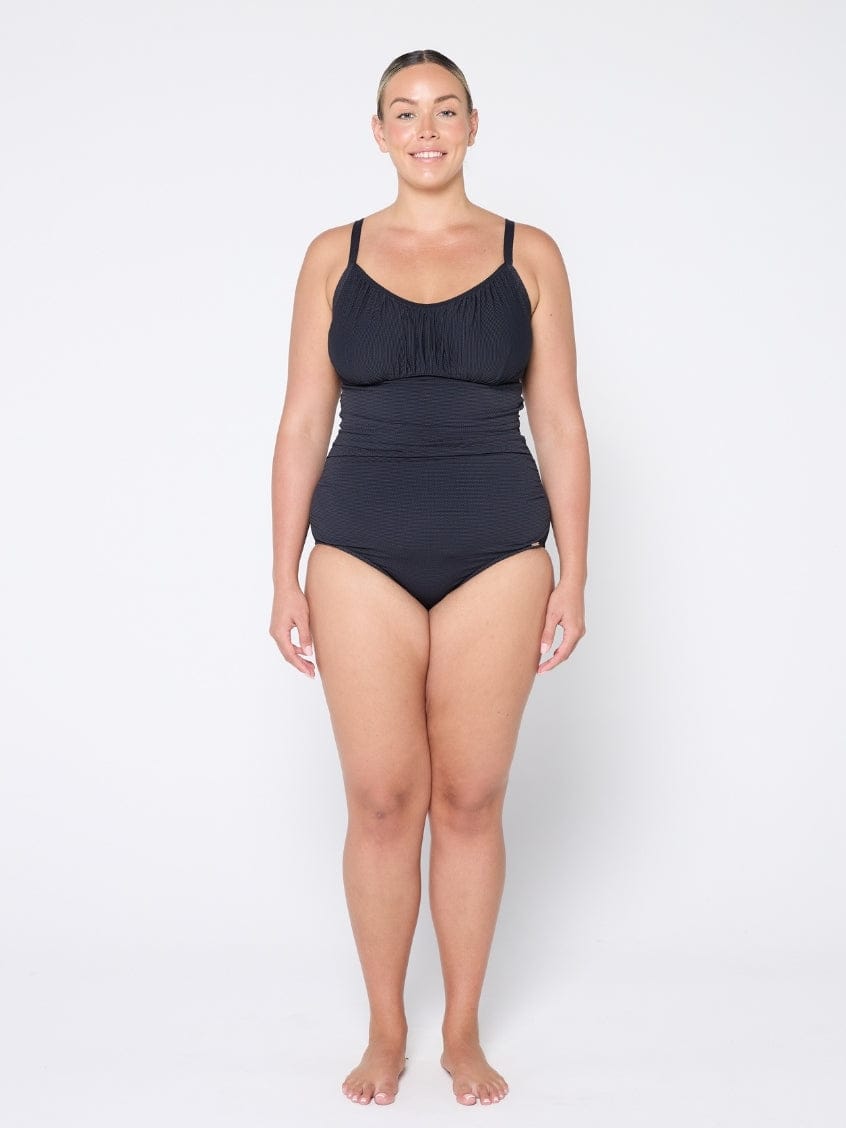 Woman wearing a black swimsuit on a white background