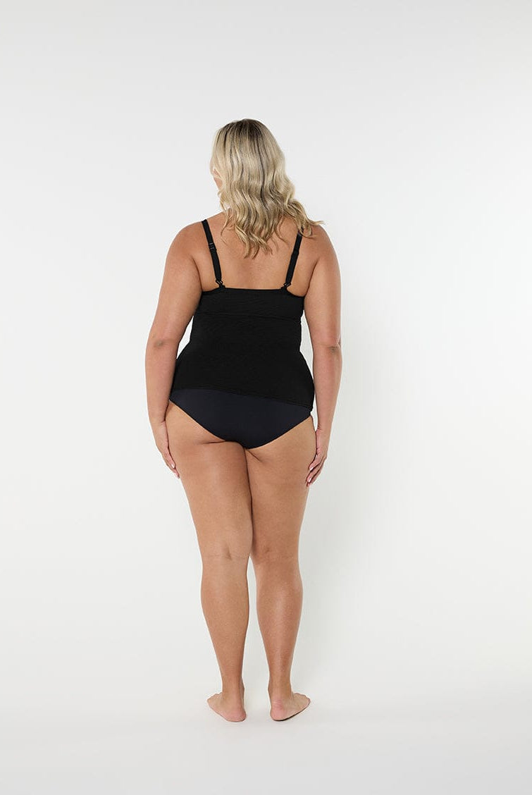 Person wearing a black swimsuit on a white background