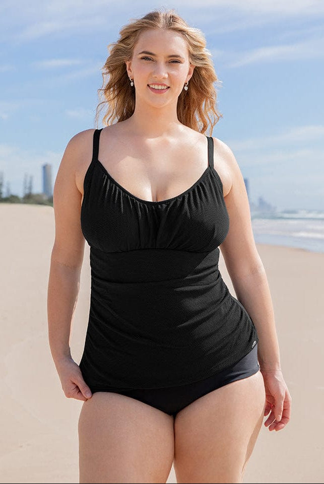 Woman wearing a black swimsuit on a beach