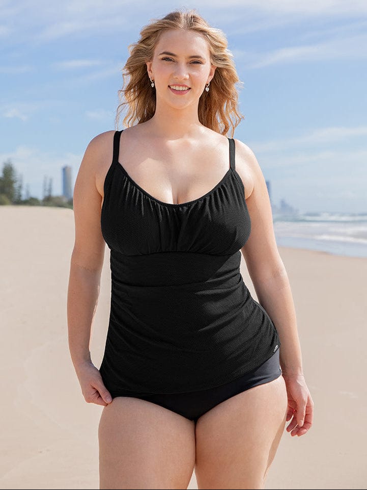 Woman wearing a black swimsuit on a beach