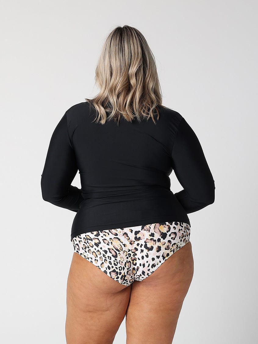 Plus size brunette model wearing size 20 black long sleeve rash vest