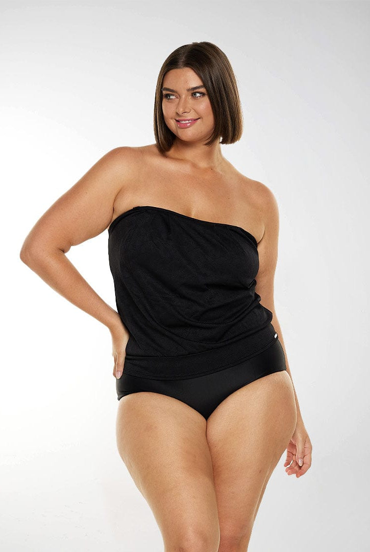Brunette plus size model wears black bandeau tankini top with removable straps