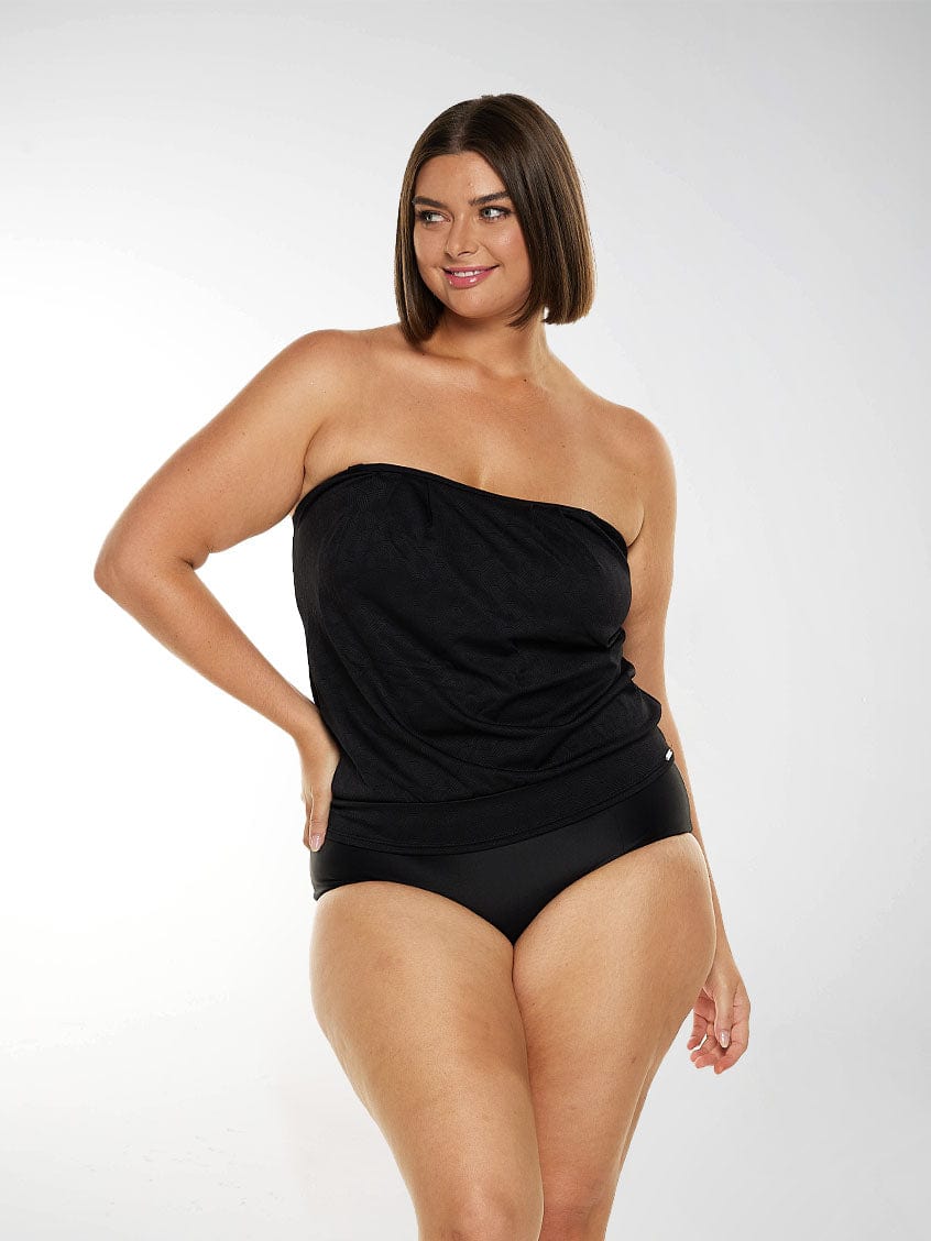 Brunette plus size model wears black bandeau tankini top with removable straps