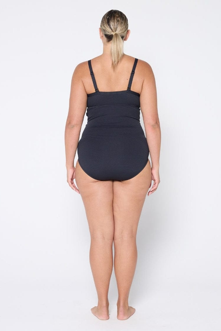 Woman wearing a black swimsuit on a white background