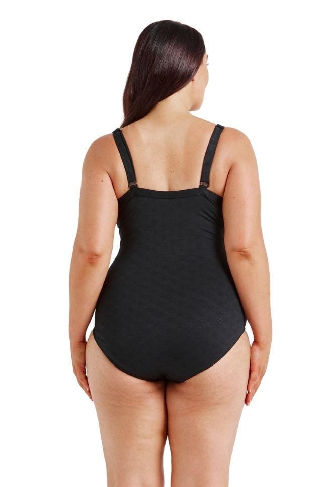Brunette model showing back of black textured swimsuit