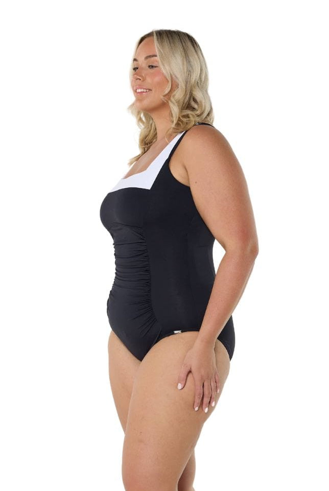 Blonde model showing side of black and white square neck one piece
