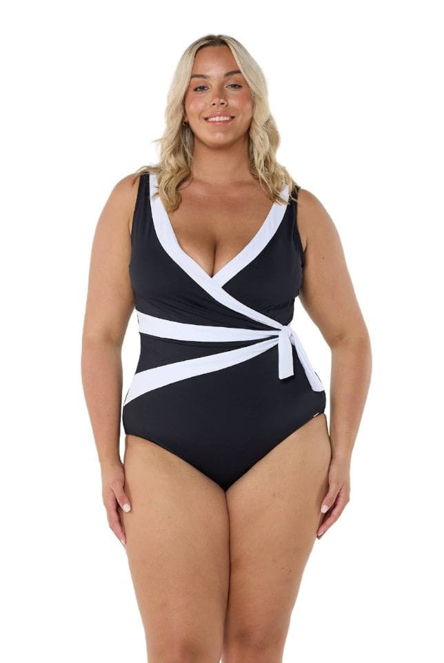 Model wearing black and white waist tie one piece