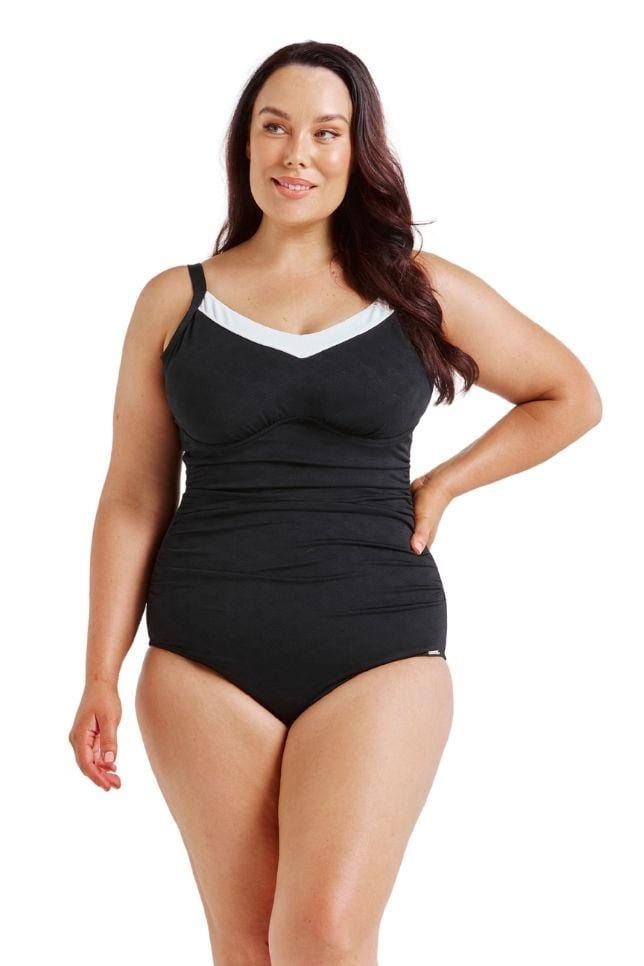 Brunette model wearing black and white underwire one piece