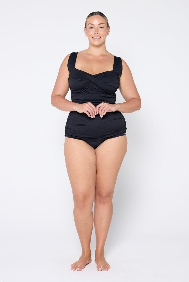 Woman wearing a black swimsuit on a white background
