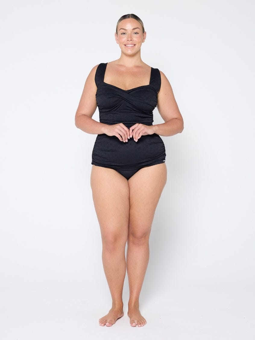 Woman wearing a black swimsuit on a white background