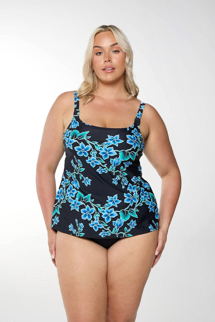 Blonde women shows front of square neck tankini top in blue floral design