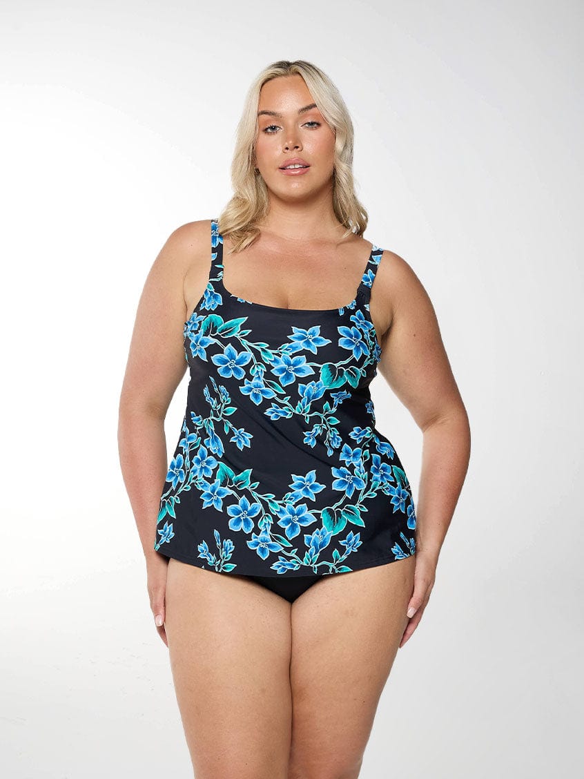 Blonde women shows front of square neck tankini top in blue floral design