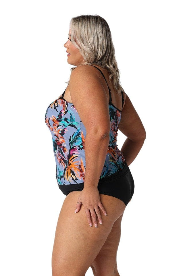 Side profile of blonde model wearing tropical floral grey based print in flouncy bandeau style for curve women