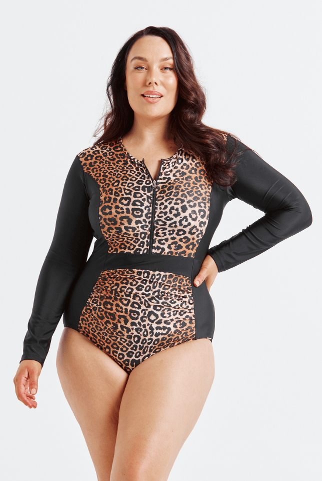 Woman wearing a leopard print and black long-sleeve swimsuit on a white background