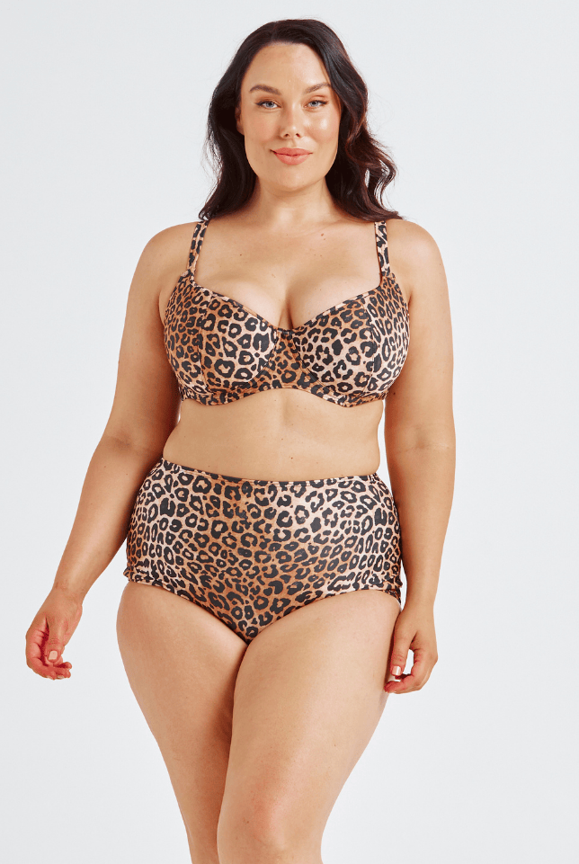 Woman wearing a leopard print bikini set on a white background