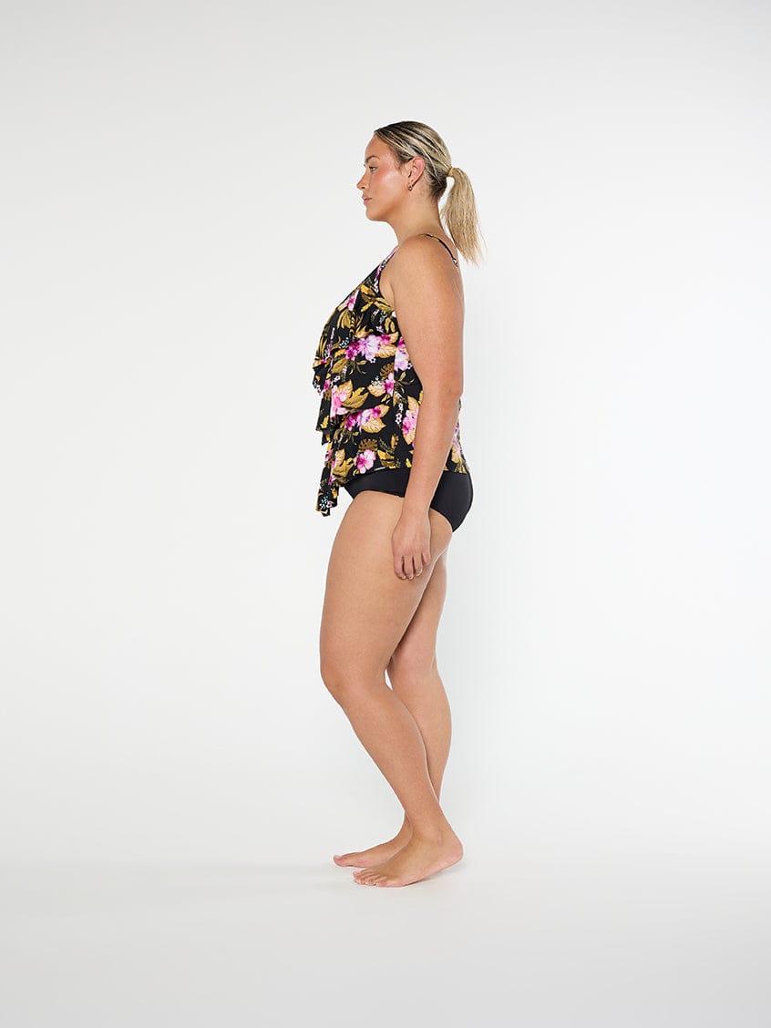 Woman wearing a floral two-piece swimsuit on a white background