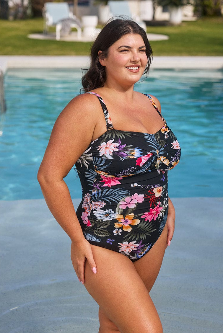 Woman wearing a floral swimsuit by a pool