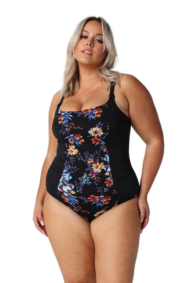 Blonde model in studio wearing plus size one piece with panelled floral print in chlorine resistant fabric