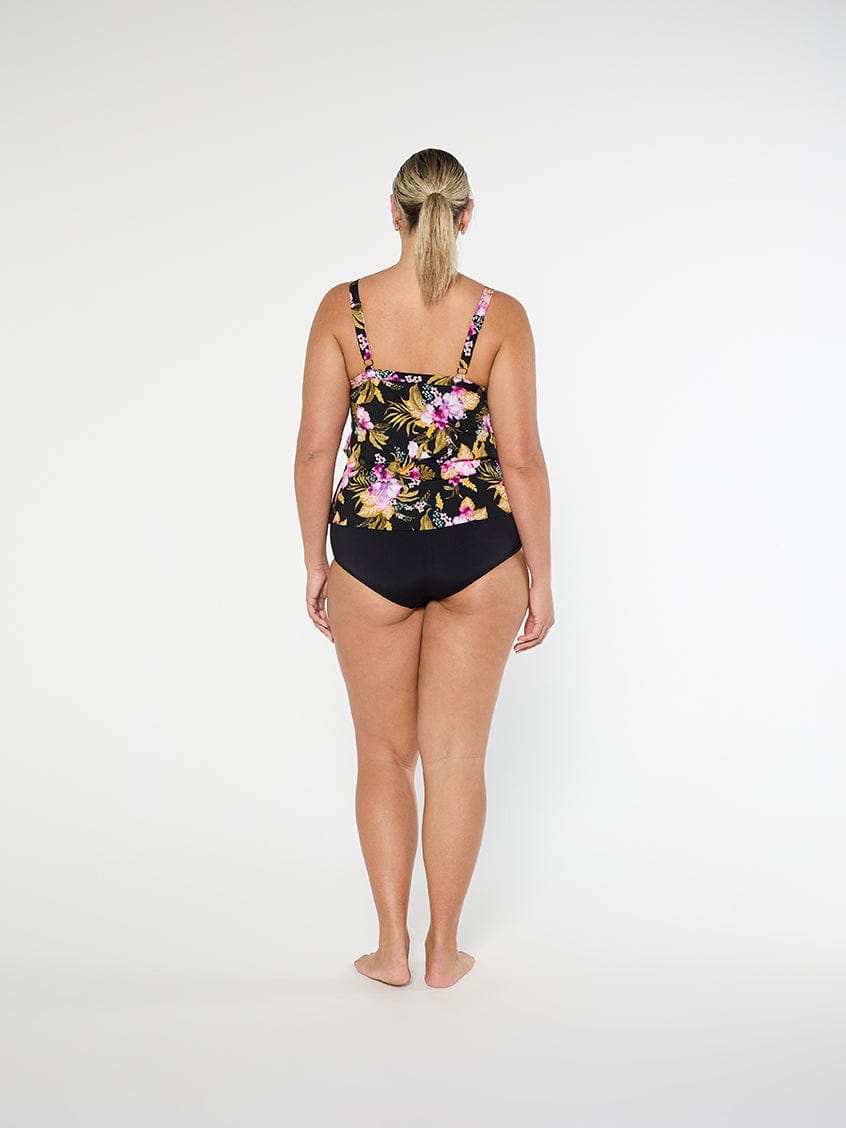 Woman wearing a floral swimsuit on a white background