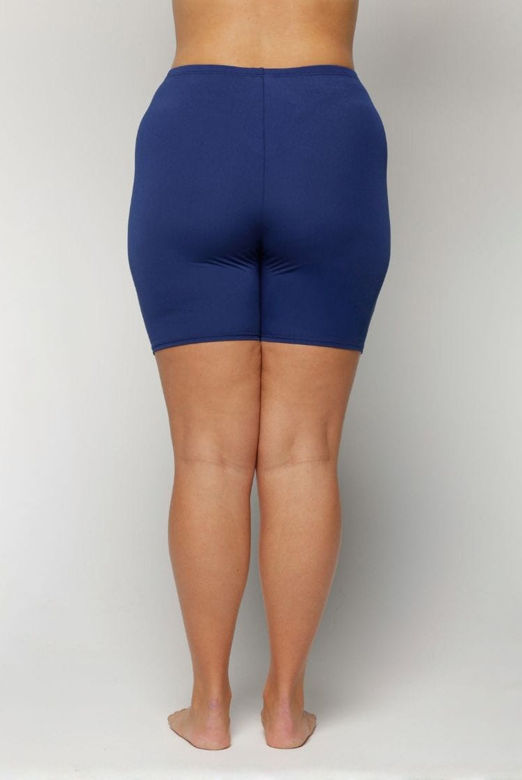 Person wearing blue swim shorts chlorine resistant on a plain background