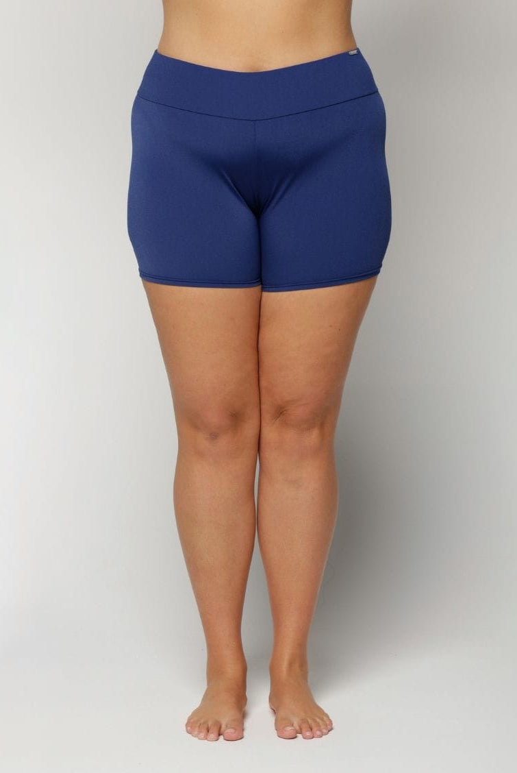 Curve women wearing navy chlorine resistant on a plain background
