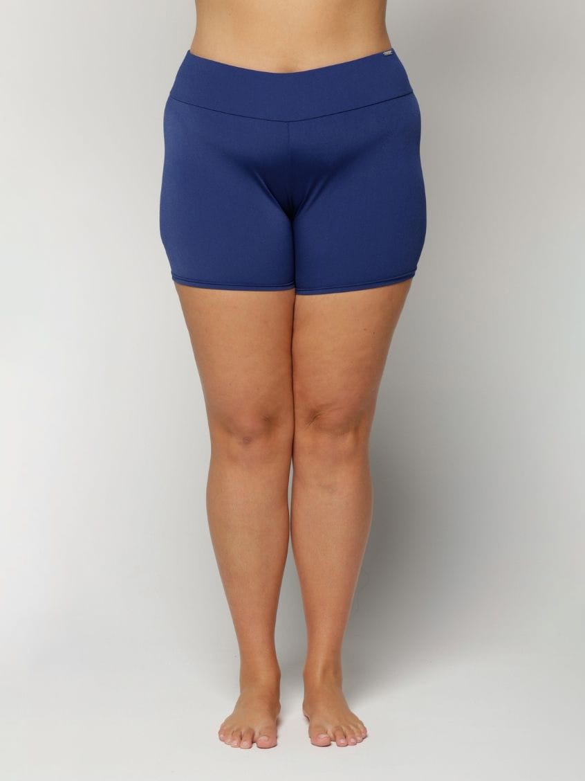 Curve women wearing navy chlorine resistant on a plain background